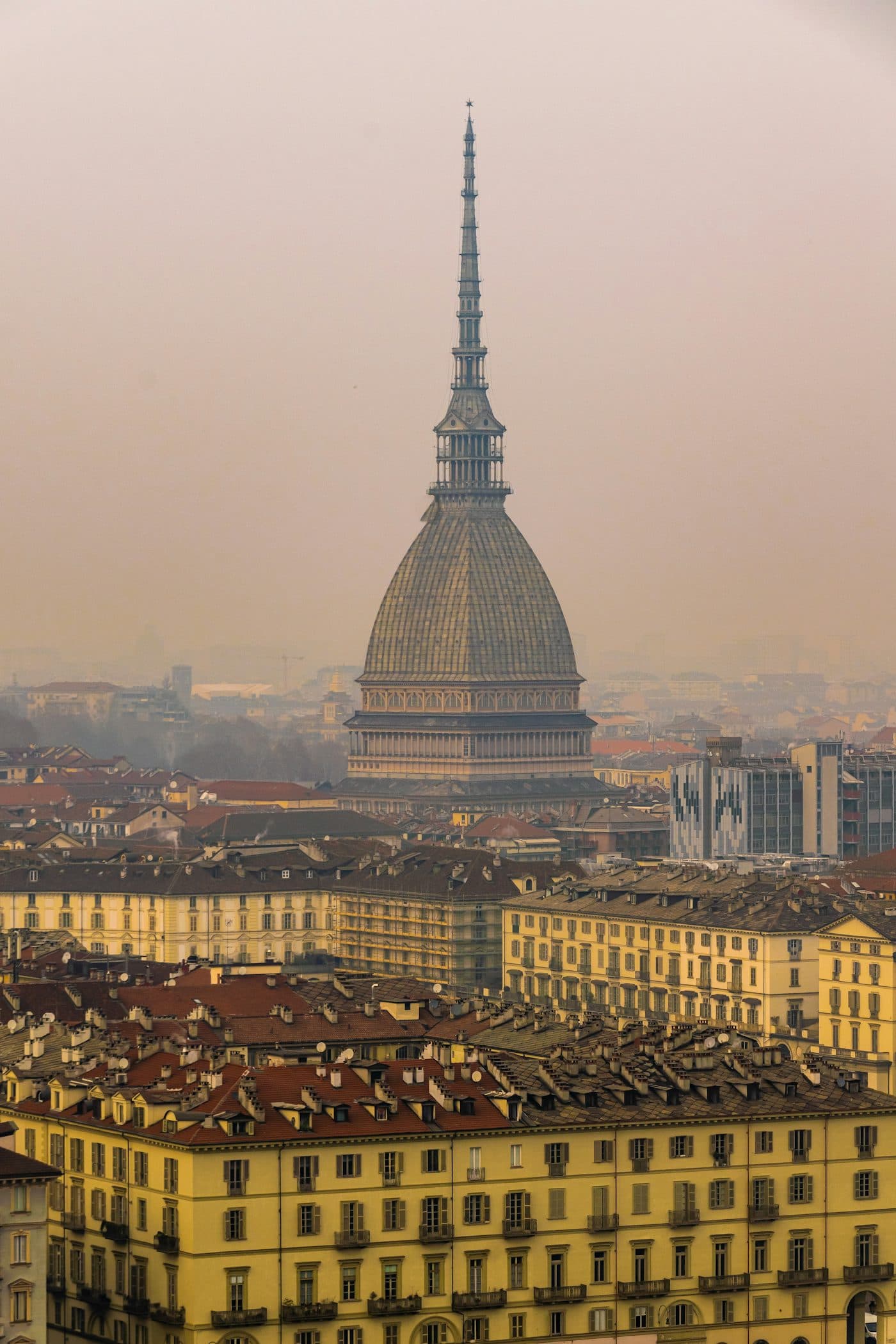The Mole Antonelliana rising over Turin's skyline, with the Alps behind it